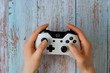 White gamepad to play with the Xbox that holds women's hands