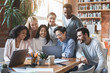 © Prostock-studio - Excited international team looking at notebook screen, watching presentation