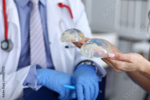 Cuadros en Lienzo Close-up of female hands holding silicone implants in hands