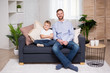 © Di Studio - happy father with little son sitting in living room