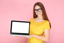 Young Woman Showing Blank Laptop Screen On Pink Background