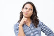 © Mangostar - Thoughtful young woman with finger on cheek. Beautiful pensive young woman holding hand on chin and pouting lips on white background. Thinking concept