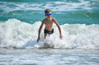 © Victoria - Child boy jumping on sea waves. Happy child in the ocean.