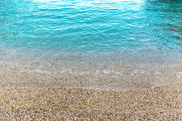 Wall Mural - Clear sea water background with pebbles. Mediterranean sea