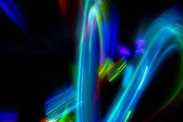 Wall Mural - Abstract color pattern of luminous stripes on a black background, bright and smooth color streaks