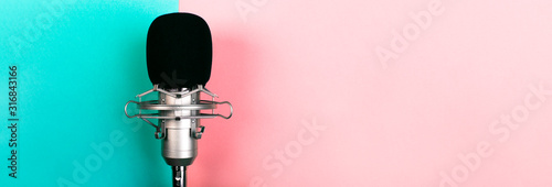 Fotografía studio microphone on a blue pink background, panoramic mock-up with space for te