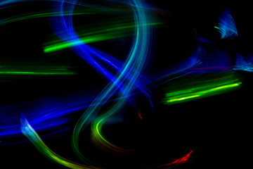 Wall Mural - Abstract color pattern of luminous stripes on a black background, bright and smooth color streaks