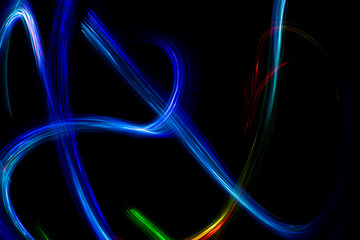 Wall Mural - Abstract color pattern of luminous stripes on a black background, bright and smooth color streaks