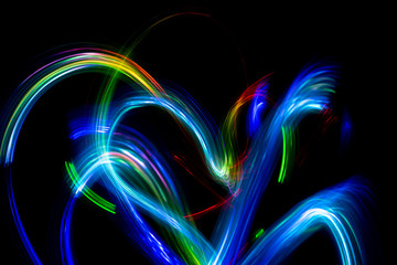 Wall Mural - Abstract color pattern of luminous stripes on a black background, bright and smooth color streaks