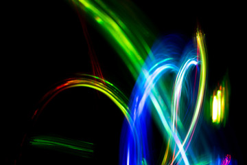 Wall Mural - Abstract color pattern of luminous stripes on a black background, bright and smooth color streaks