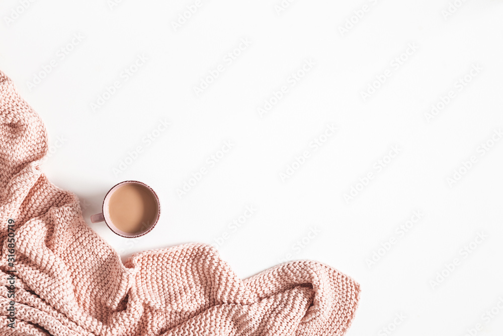 Cup of coffee, pink blanket on white background. Flat lay, top view, copy space - obrazy, fototapety, plakaty 