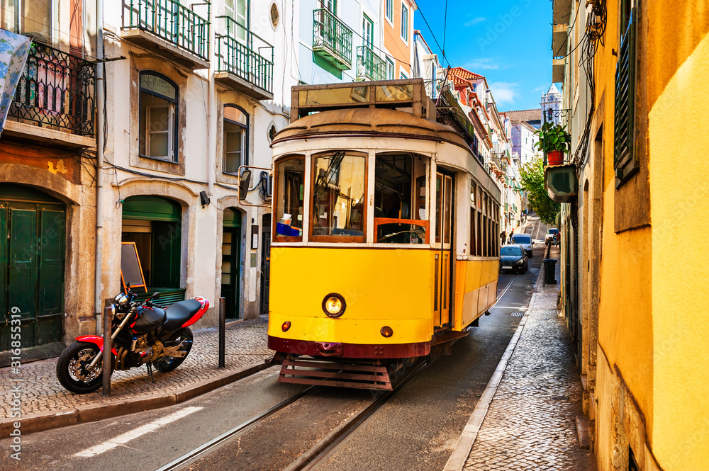 Yellow vintage tram on the street in Lisbon, Portugal. Famous travel destination - obrazy, fototapety, plakaty 