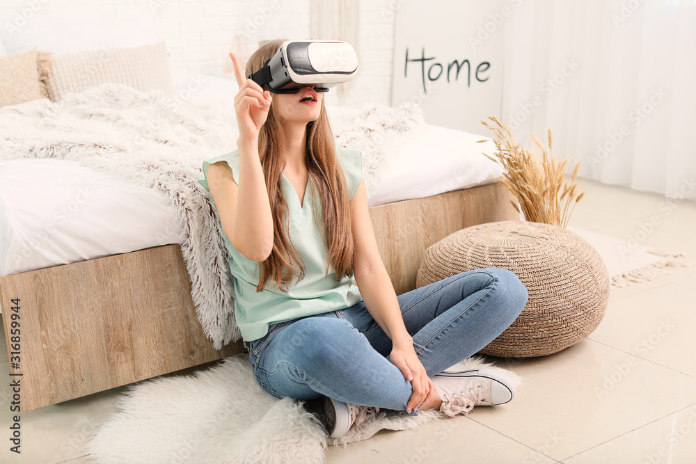 Young woman with virtual reality glasses at home
