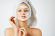 © Olesia - Cosmetology, skin care, face treatment, spa and natural beauty concept. Woman with facial mask.