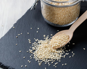 heap of sesame seeds on a dark background