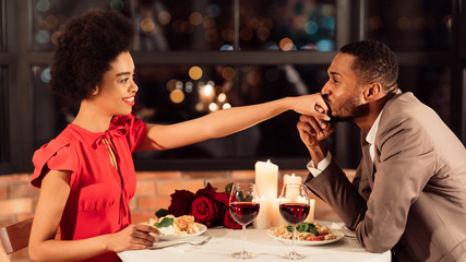 African American Boyfriend Kissing Girlfriend's Hand Dating In Restaurant, Panorama