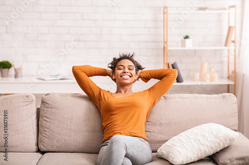 Photographie Happy Black Woman Relaxing Sitting On Sofa At Home