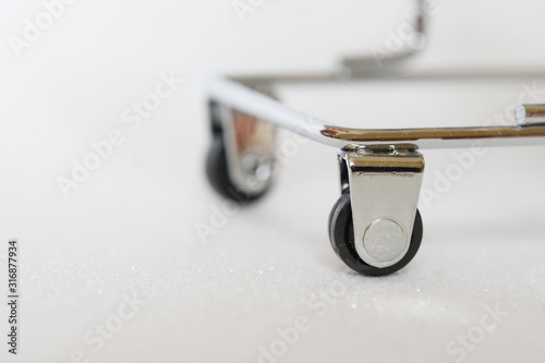 Cuadros en Lienzo Wheels of a small metal trolley, similar to a trolley for transporting corpses in a morgue