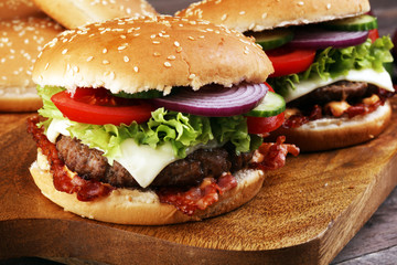 Tasty fresh meat burgers with salad and cheese. Homemade angus burger.