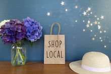 "Shop Local" Text On A Plain Brown Paper Bag With Flowers And Stars - Summer, Night Shopping Message Concept