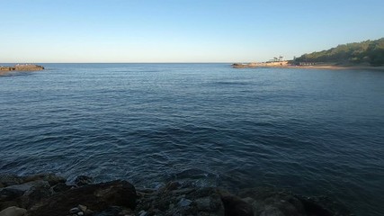 Wall Mural - sea bay with blue water and beach at sunset