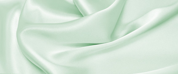 Wall Mural - Draped satin green fabric for festive backgrounds