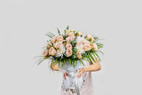 Fototapeta  - Young pretty woman hold luxurious bouquet.