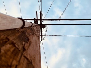 Low angle view of looking up a wooden power line pole