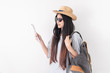 © weedezign - Asian woman traveler backpacker use map and mobile phone app to search for route location of place with gps on white background,Technology in lifestyle