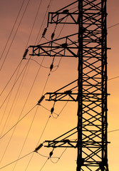 Electric pole with wires on a sunset background