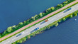 Aerial drone view of motorway road and cycling path on polder dam, cars traffic from above, North Holland, Netherlands