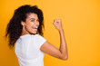 Photo of brunette haired cheerful cute nice curly wavy trendy youngster showing the power in her muscular arm shouting satisfied about her achievement isolated vivid color background in white t-shirt