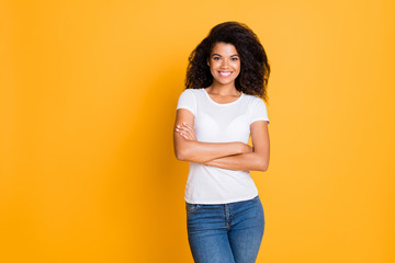 Poster - Photo of wavy cheerful positive cute nice pretty girlfriend in jeans denim white t-shirt smiling toothily isolated over vivid color background with arms crossed