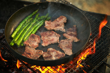 Poster - Cooking beef with asparagus on frying pan 