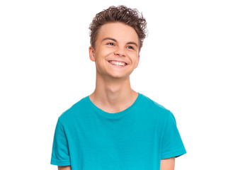 Wall Mural - Handsome caucasian Teen Boy in blue t-shirt, isolated on white background. Teenager looking away and smiling. Happy child - close-up portrait.