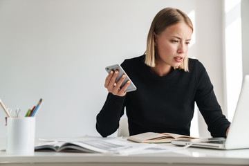 Poster - Business woman in office work with documents and phone.