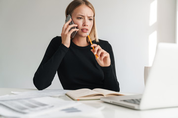 Wall Mural - Business woman talking by mobile phone.