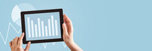Hands Using Tablet Computer Analyzing Business Graphs On Blue Copy Space Web Banner Background.