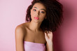 portrait of young curly african american woman on pink