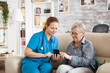 © DC Studio - Pretty nurse helping senior woman how to use mobile phone