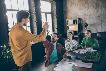 Portrait of four nice attractive cheerful cheery glad professional people IT recruiter meeting welcoming clapping palms at industrial loft interior open space style workplace workstation