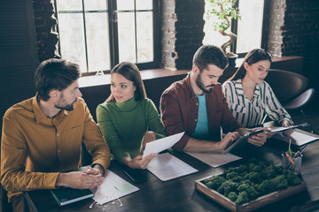 Wall Mural - Four people smart emotions chief managers sit table desk have job applicant interview read cv use tablet tell talk say speak discus decide hire him her in workstation workplace