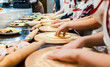 © xartproduction - Children cook pizza. Master class from the chef in a restaurant, Close-up of children's hands roll out the dough