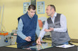 © auremar - trainer giving advice to the glass manufacturing apprentice