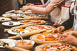 © xartproduction - Children cook pizza. Master class from the chef in a restaurant, Close-up of children's hands roll out the dough