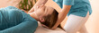 Female physiotherapist or a chiropractor adjusting patients neck. Physiotherapy, rehabilitation concept. Cropped shot banner.