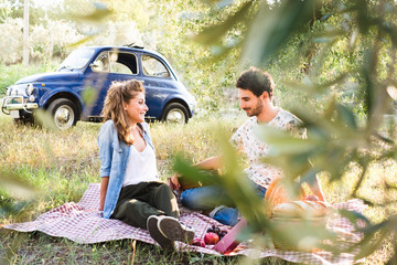 Beautiful couple in love having a picnic