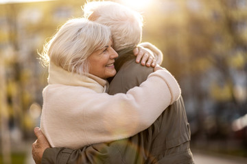 Poster - Senior couple hugging outdoors in autumn