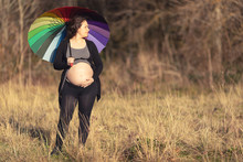 Pregnant Woman With Umbrella Sunbathing Her Belly