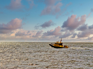 Poster - A pilot boat heading out of the harbor in the dawn light